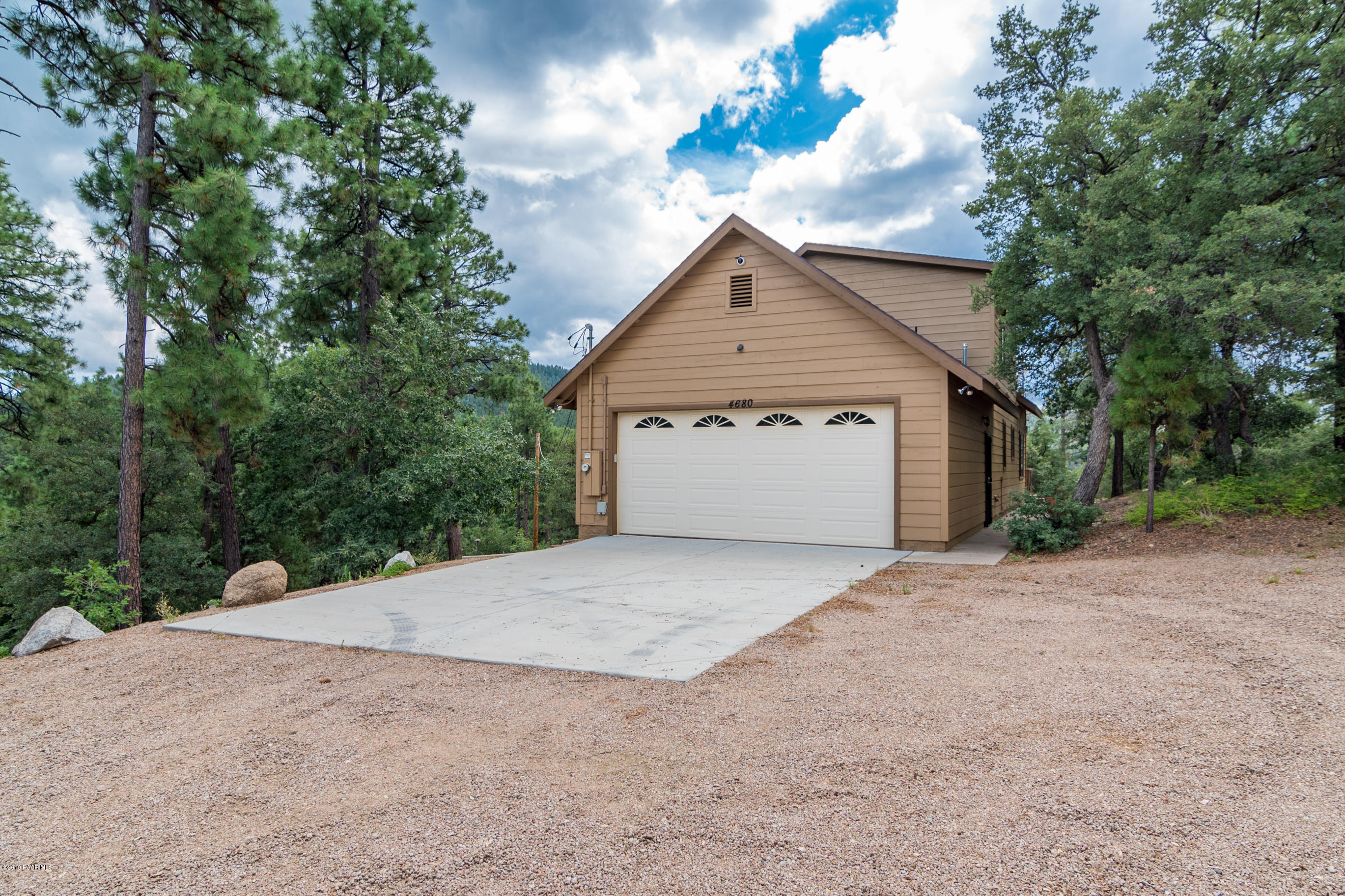 4680 South Stoney Ridge Road Prescott, AZ 86303 - Photo 12 of 39 a front view of a house with a yard and garage
