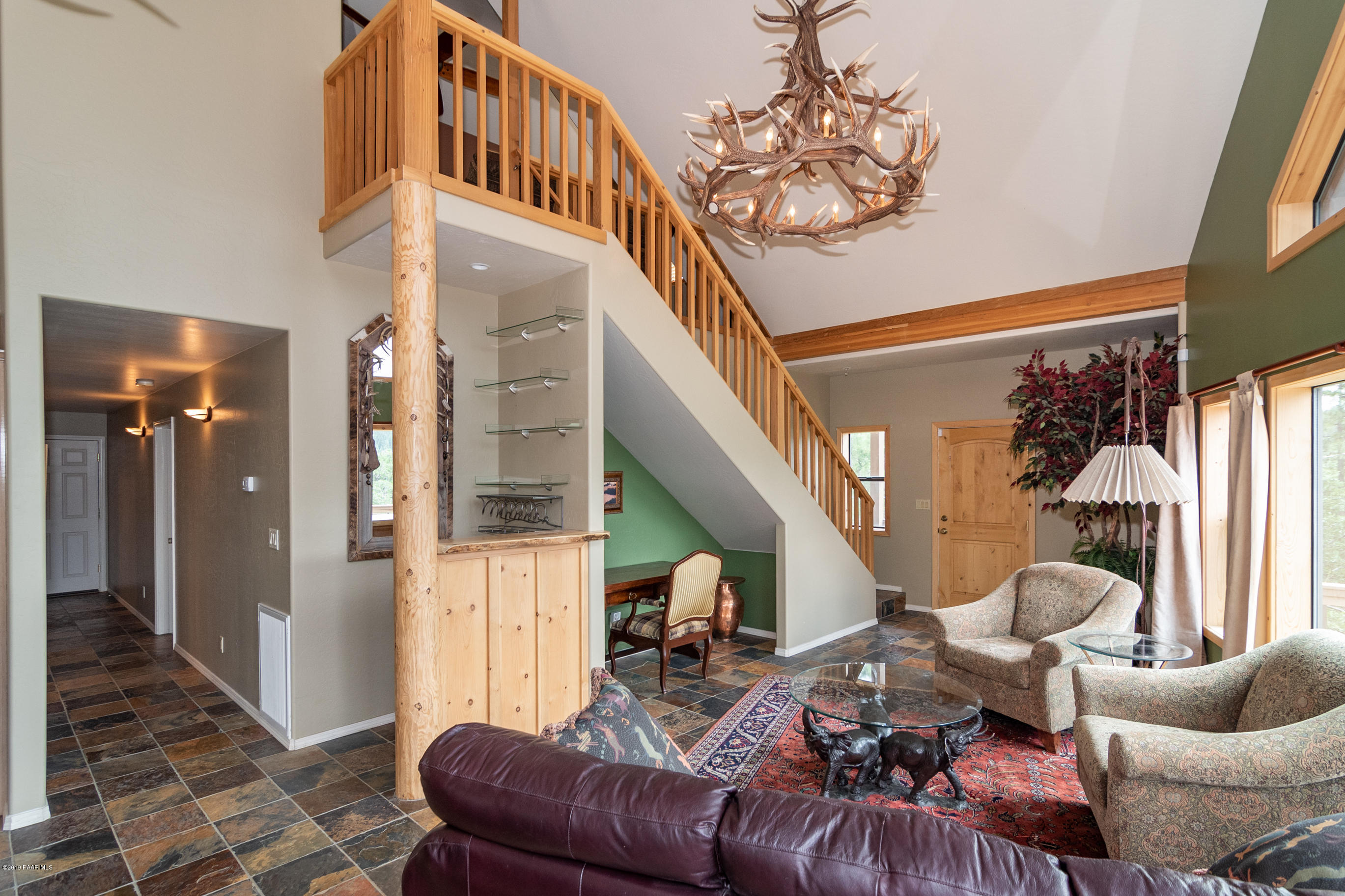 4680 South Stoney Ridge Road Prescott, AZ 86303 - Photo 19 of 39 a living room with furniture and a chandelier