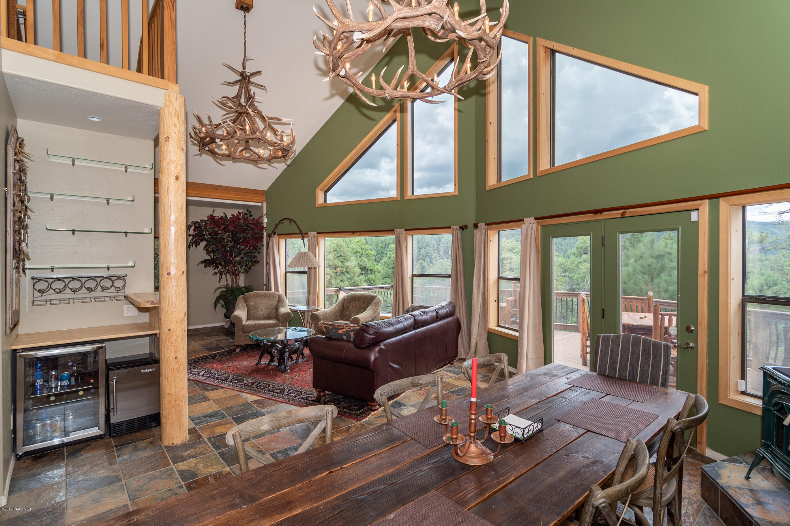 4680 South Stoney Ridge Road Prescott, AZ 86303 - Photo 21 of 39 a living room with furniture a large window and a dining table