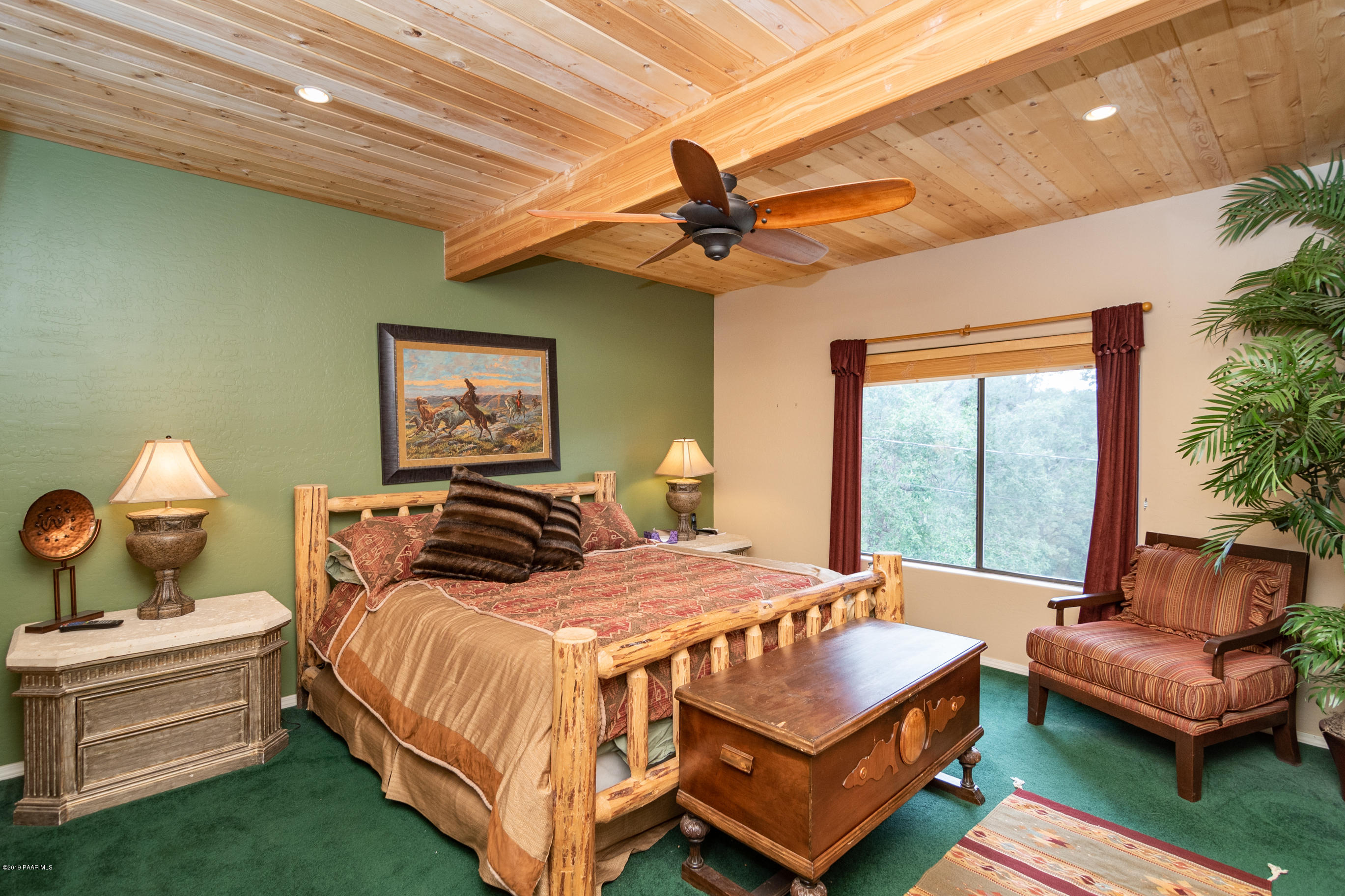 4680 South Stoney Ridge Road Prescott, AZ 86303 - Photo 26 of 39 a bedroom with a bed and a chandelier