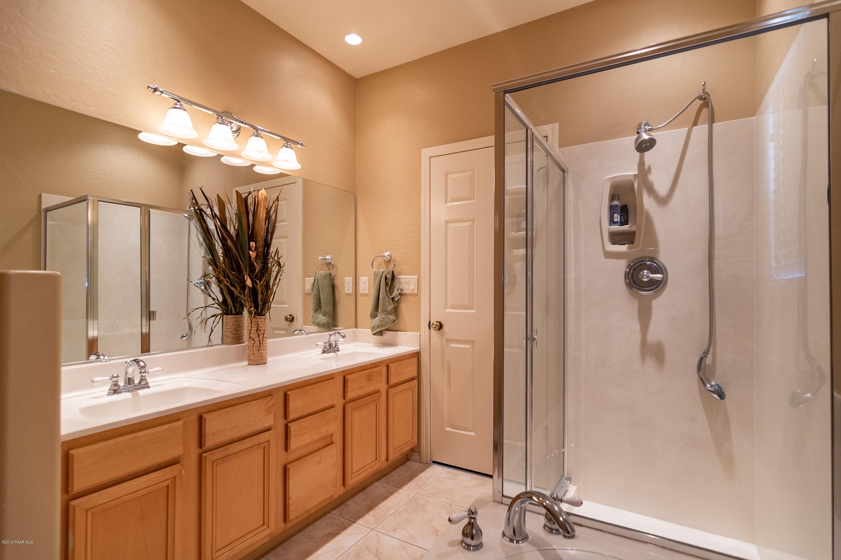 4680 South Stoney Ridge Road Prescott, AZ 86303 - Photo 28 of 39 a bathroom with a double vanity sink mirror and shower