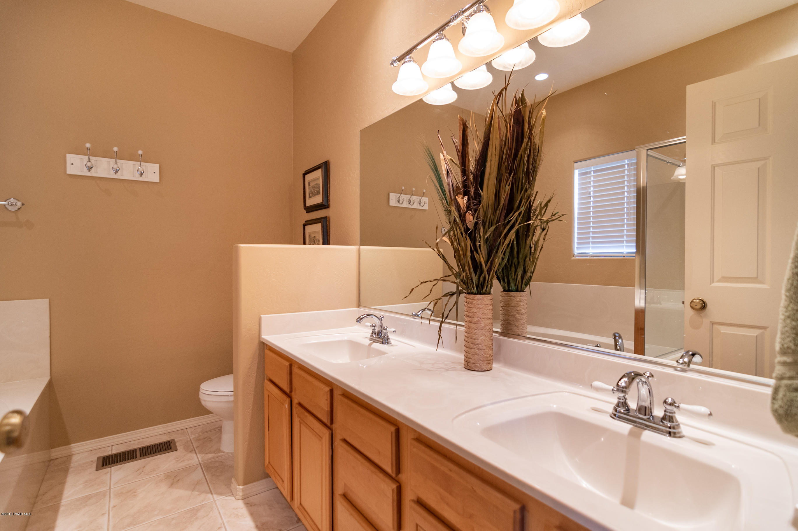 4680 South Stoney Ridge Road Prescott, AZ 86303 - Photo 30 of 39 a bathroom with a sink a toilet and a mirror
