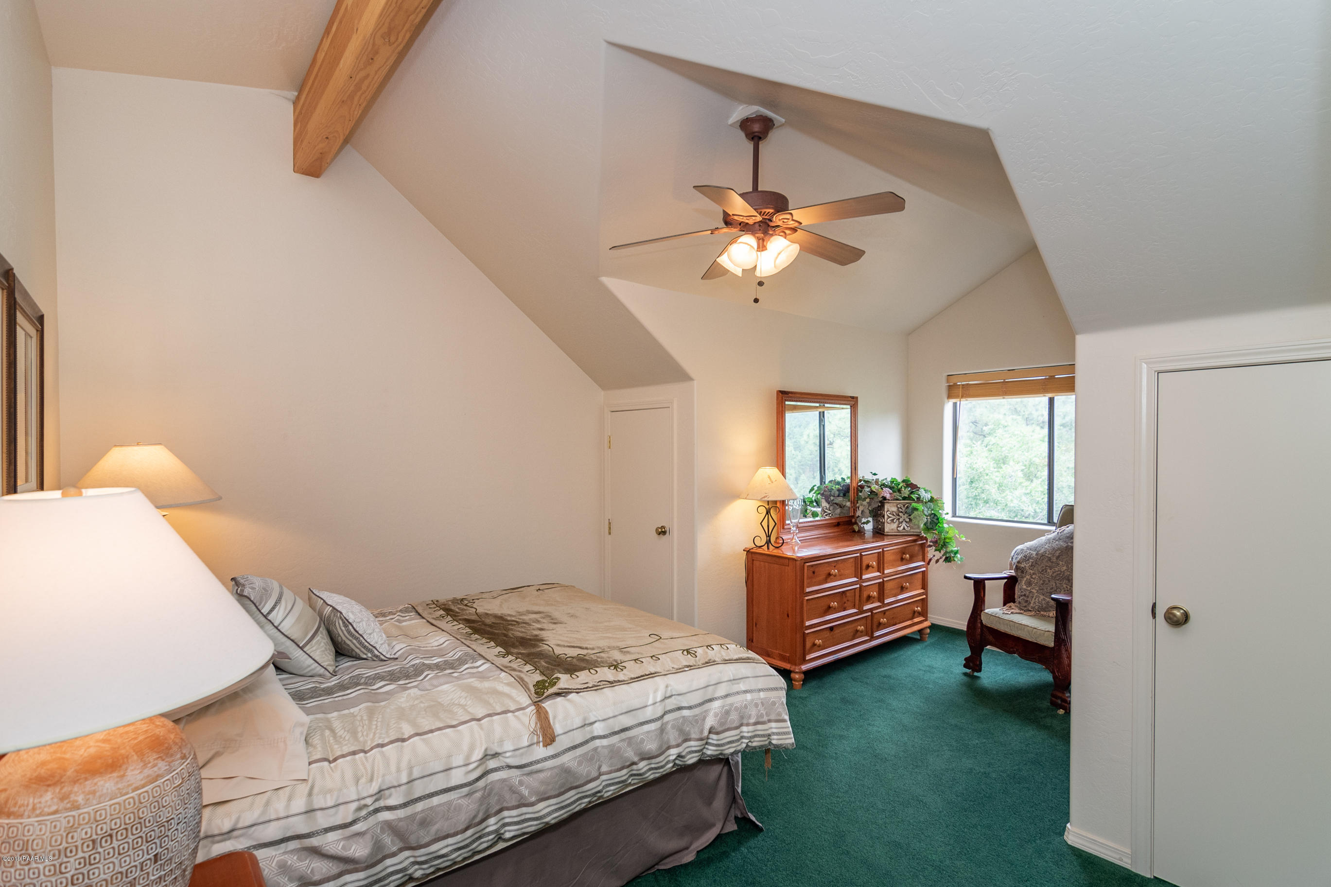4680 South Stoney Ridge Road Prescott, AZ 86303 - Photo 37 of 39 a bedroom with a bed and a chandelier