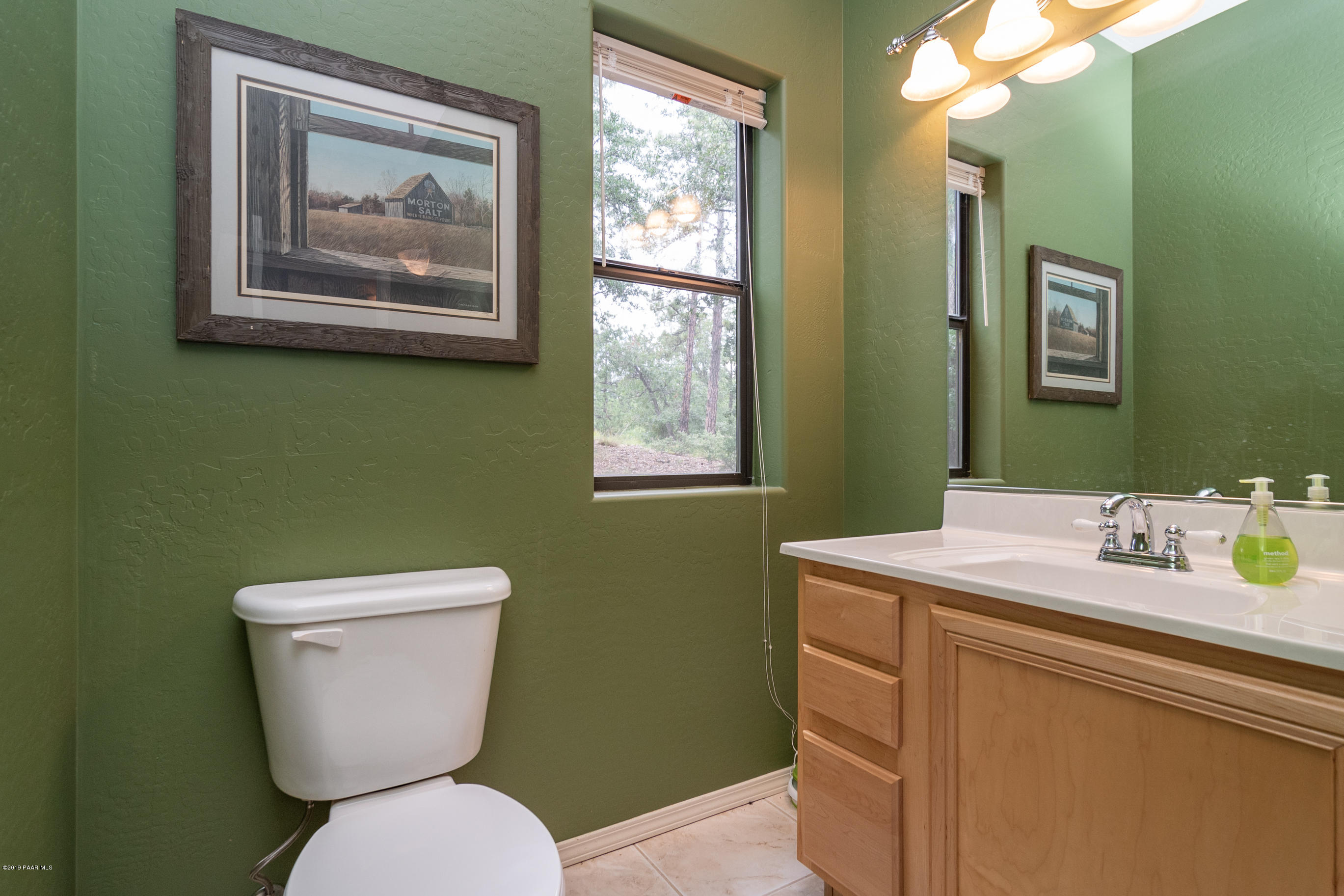 4680 South Stoney Ridge Road Prescott, AZ 86303 - Photo 38 of 39 a bathroom with a toilet a sink and a mirror
