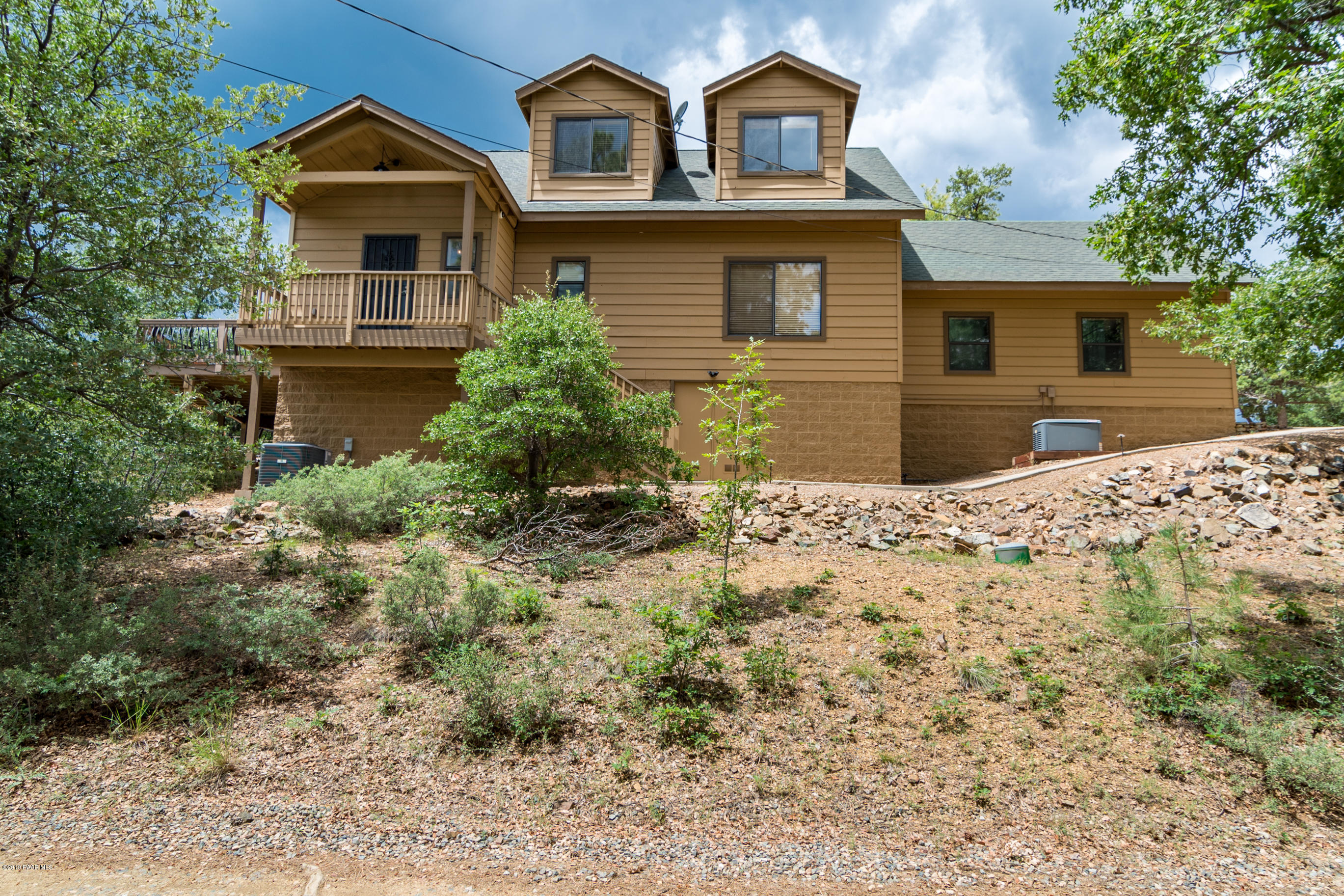 4680 South Stoney Ridge Road Prescott, AZ 86303 - Photo 10 of 39 a front view of a house with a yard and garage