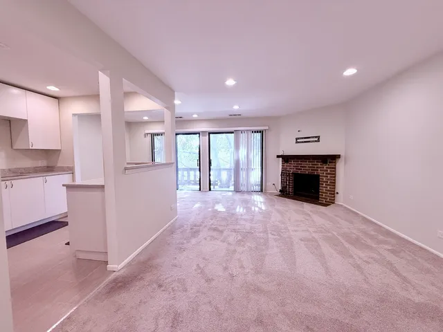 a view of an empty room with a fireplace