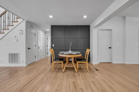 a kitchen with a sink cabinets and wooden floor