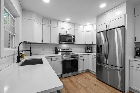 a view of a dining room with furniture and wooden floor