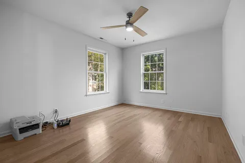 a view of a a dining room with furniture and wooden floor
