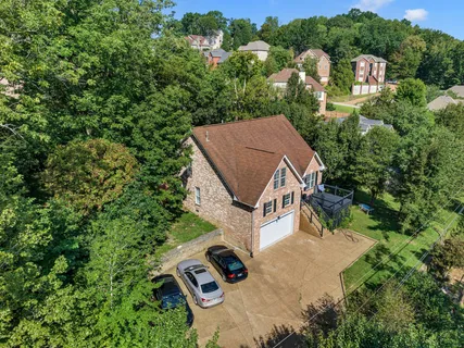 an aerial view of a house with a yard