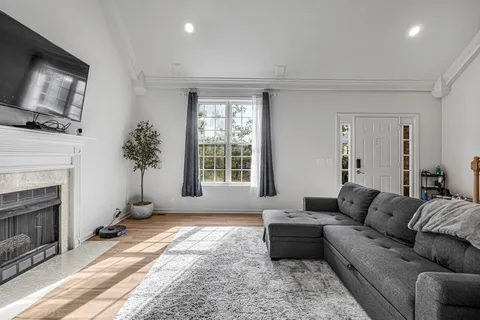 a living room with furniture fireplace and flat screen tv