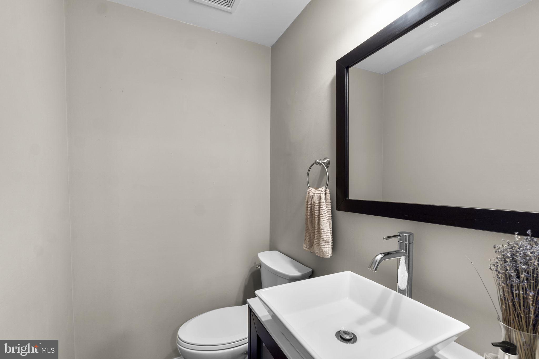 6025 Weekend Way, Unit 43 Columbia, MD 21044 - Photo 12 of 37 a bathroom with a sink a toilet and mirror