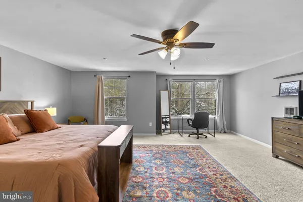 a bedroom with a bed a chandelier and a window