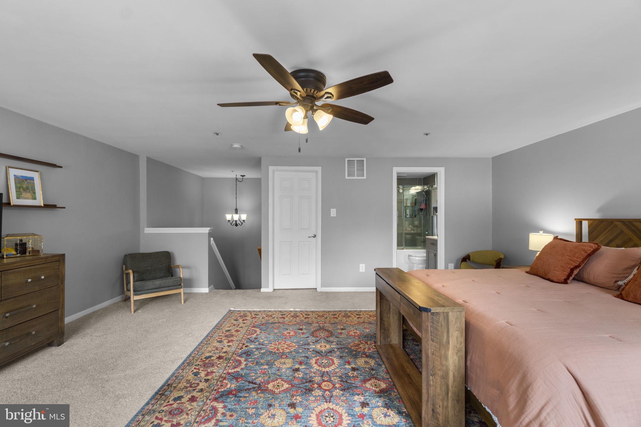 6025 Weekend Way, Unit 43 Columbia, MD 21044 - Photo 18 of 37 a bedroom with a bed and a chandelier