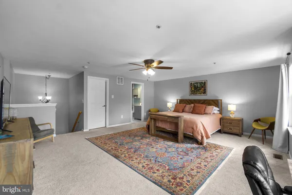 a bedroom with bed and a chandelier