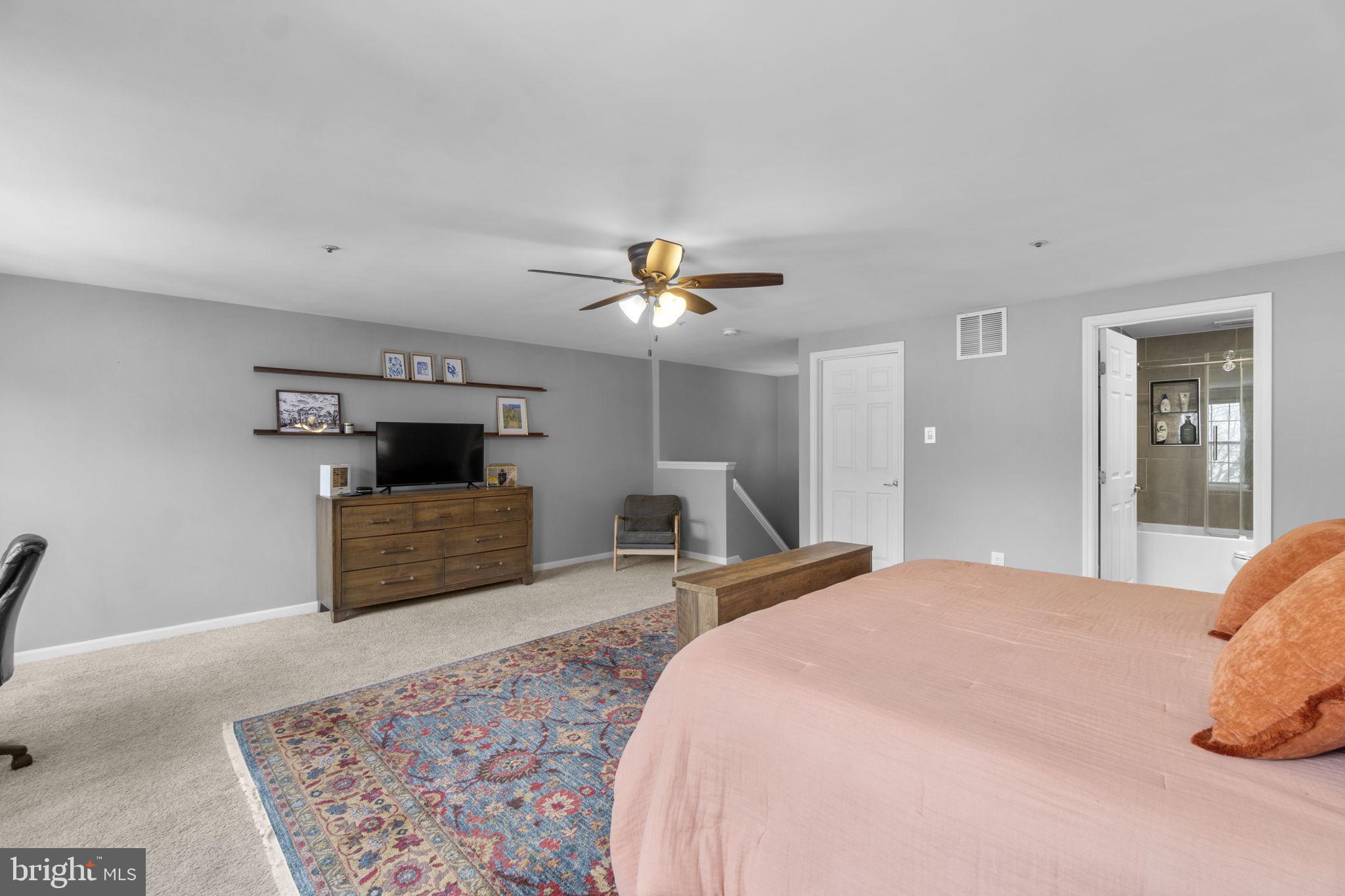 6025 Weekend Way, Unit 43 Columbia, MD 21044 - Photo 19 of 37 a bedroom with bed and a chandelier