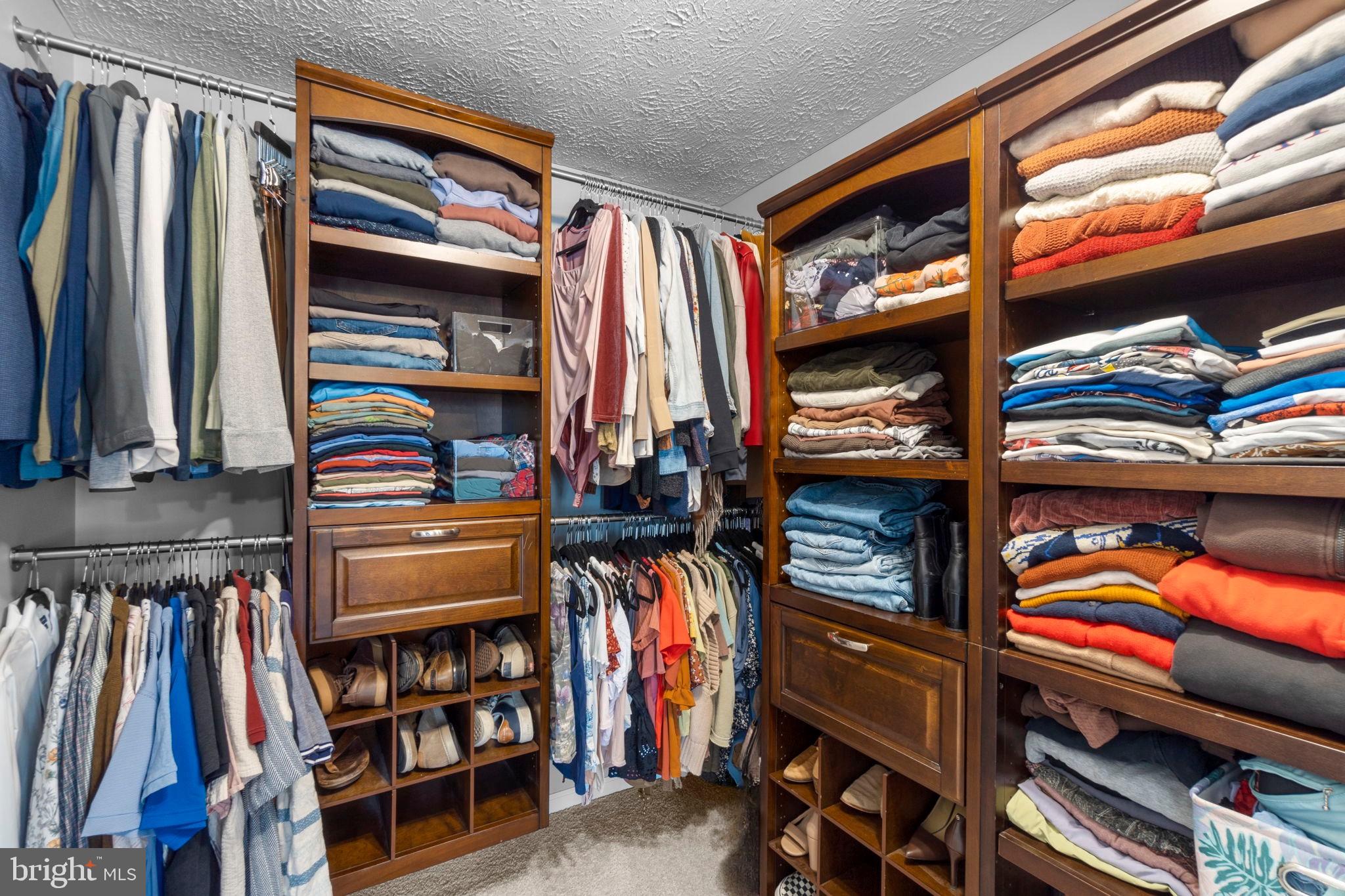 6025 Weekend Way, Unit 43 Columbia, MD 21044 - Photo 20 of 37 a view of walk in closet with clothes and shoes
