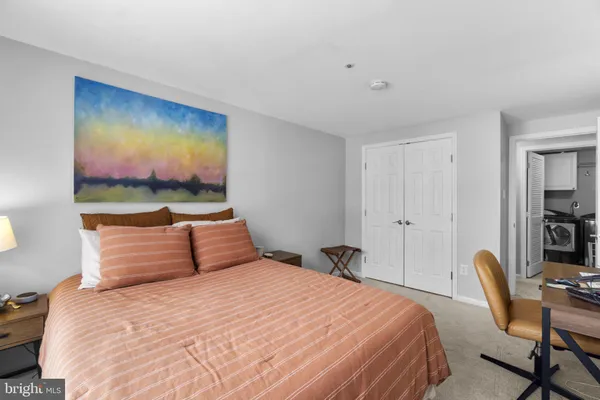 a bedroom with a bed and a desk