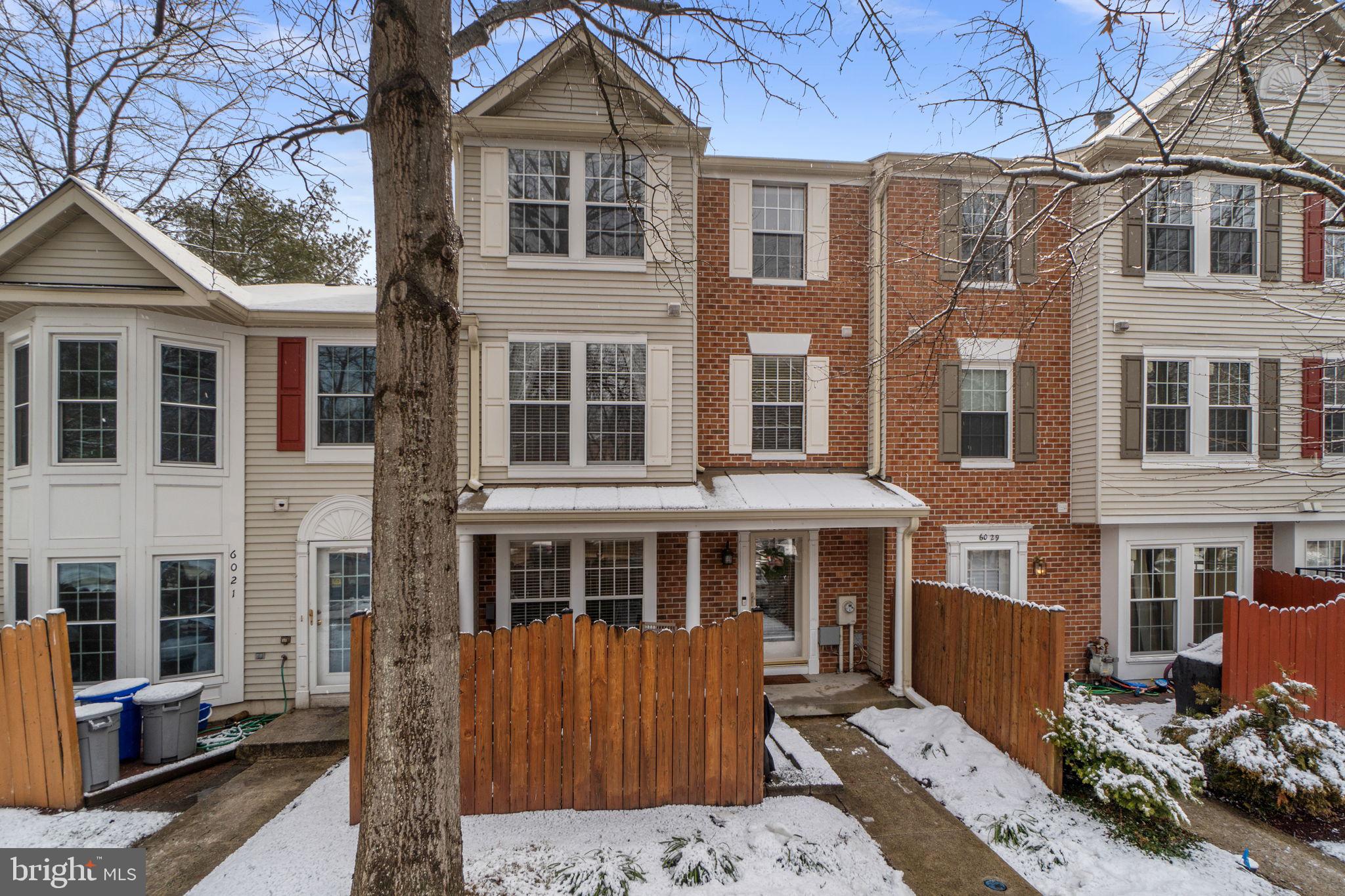 6025 Weekend Way, Unit 43 Columbia, MD 21044 - Photo 35 of 37 a front view of a residential apartment building with a yard