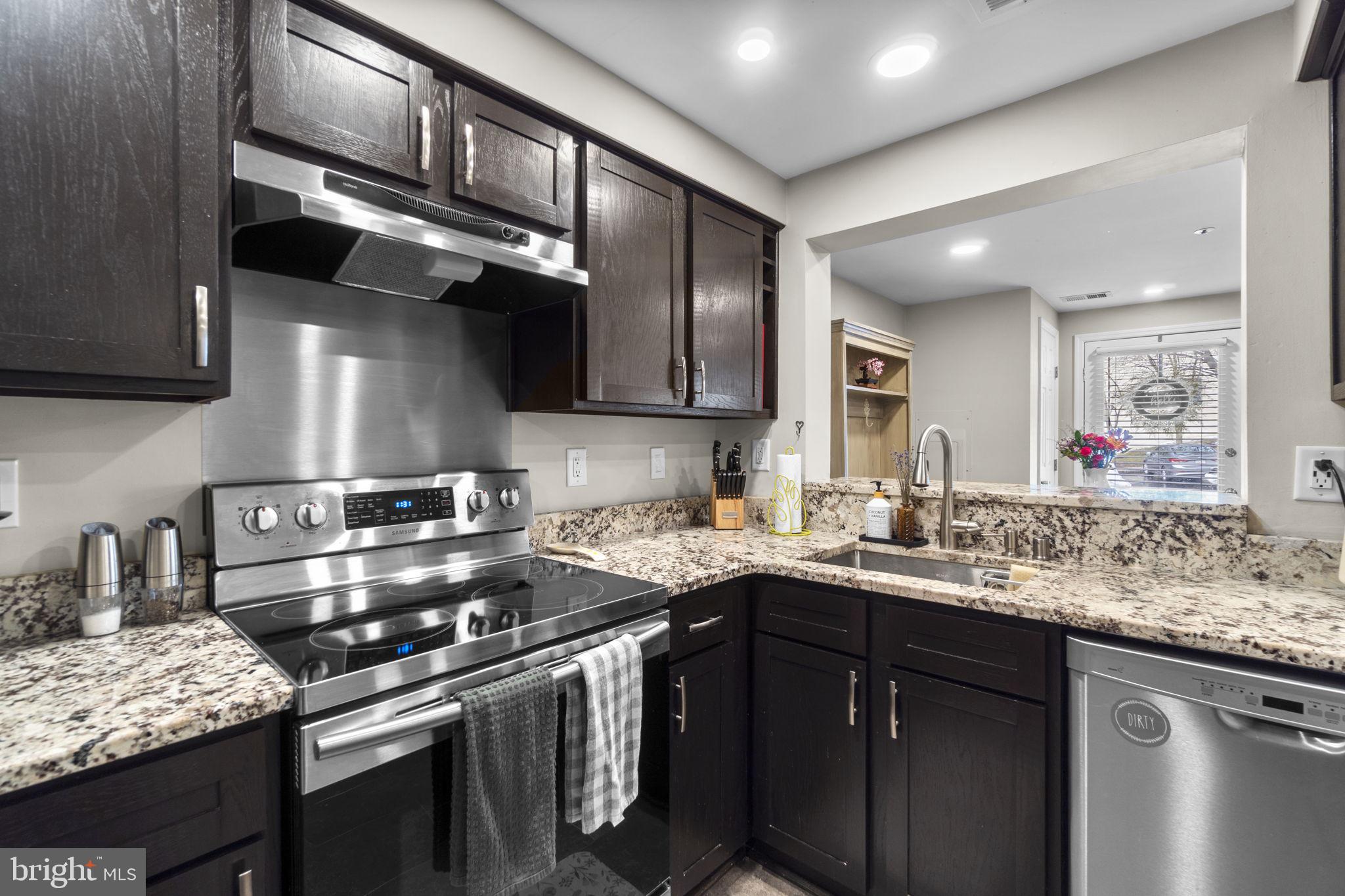 6025 Weekend Way, Unit 43 Columbia, MD 21044 - Photo 9 of 37 a kitchen with stainless steel appliances granite countertop a sink stove and cabinets