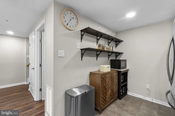 a kitchen with stainless steel appliances granite countertop a refrigerator a stove and a sink