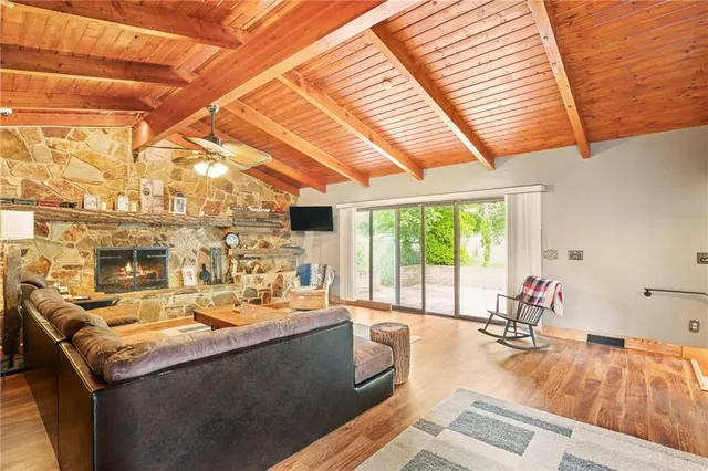 a living room with patio furniture and a large window