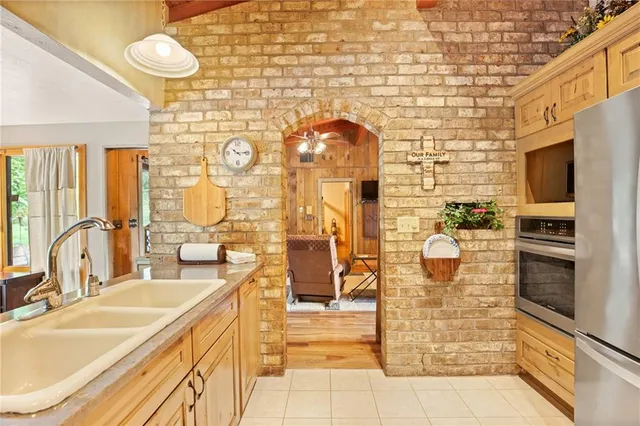 a bathroom with a granite countertop sink a large mirror and a shower