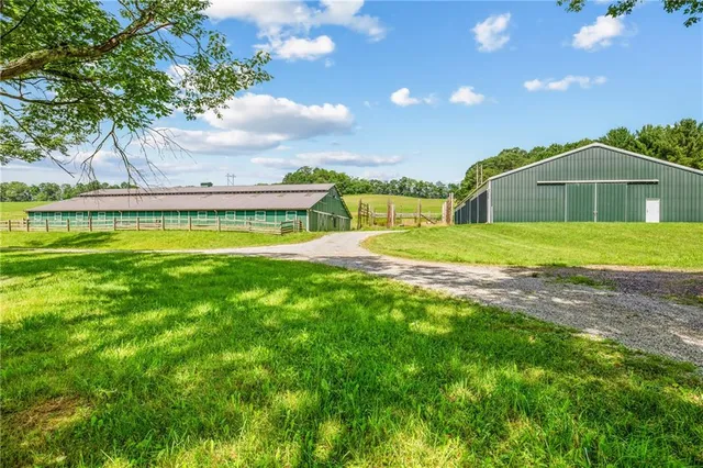 a view of a house with a yard and sitting area