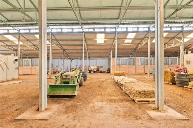 a living room with couch and floor to ceiling windows