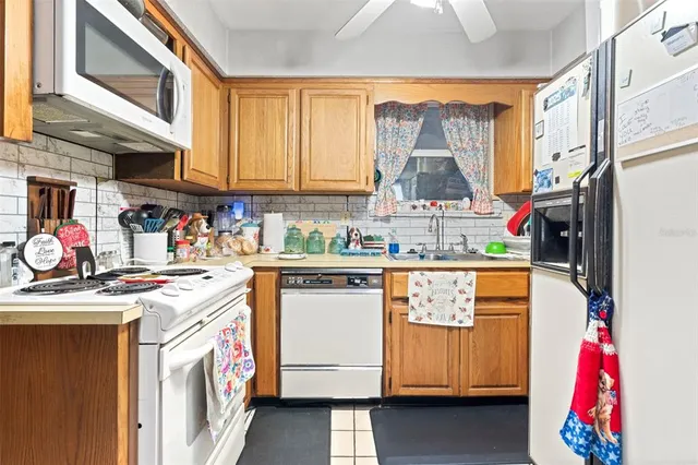 a utility room with stainless steel appliances granite countertop a stove and a refrigerator