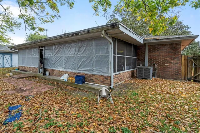 a backyard of a house with barbeque oven table and chairs
