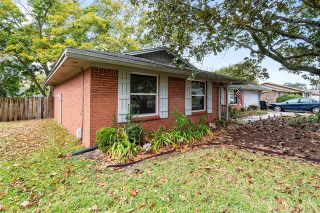 a front view of house with a garden
