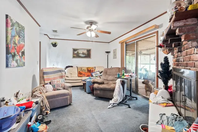 a living room with furniture a flat screen tv and a window