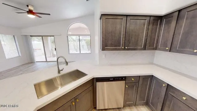 a kitchen with a sink cabinets and window