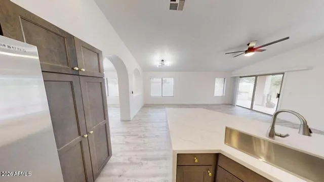 a view of a kitchen with a sink dishwasher and wooden floor