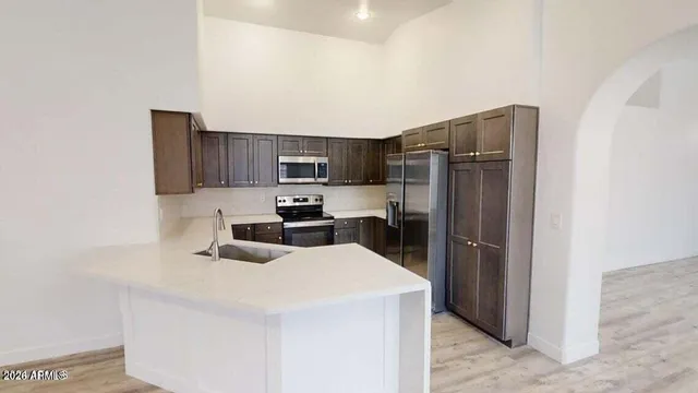 a kitchen with a refrigerator sink and microwave