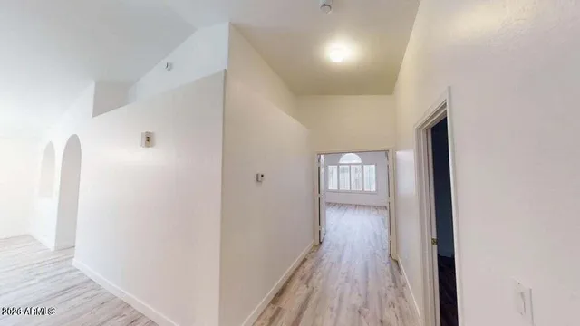 a view of a hallway with wooden floor