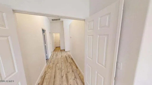 a view of a room with wooden floor