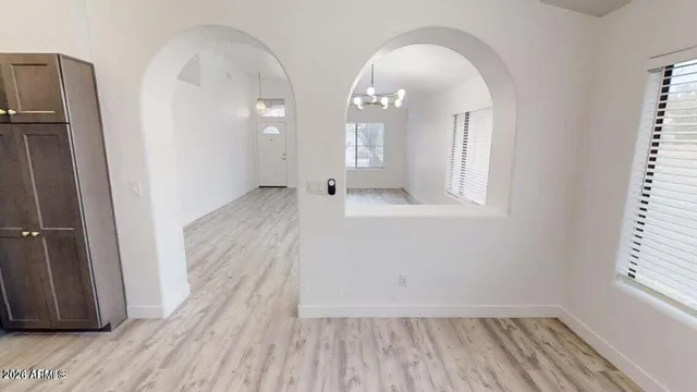 a view of a room with wooden floor and window