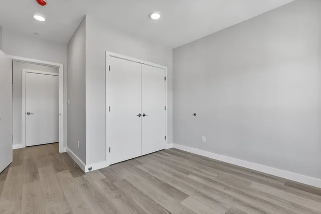 a view of room with wooden floor