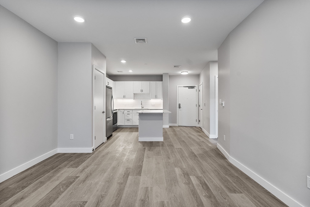 59 Mill Street, Unit 203 Woburn, MA 01801 - Photo 6 of 19 a view of a kitchen with wooden floor