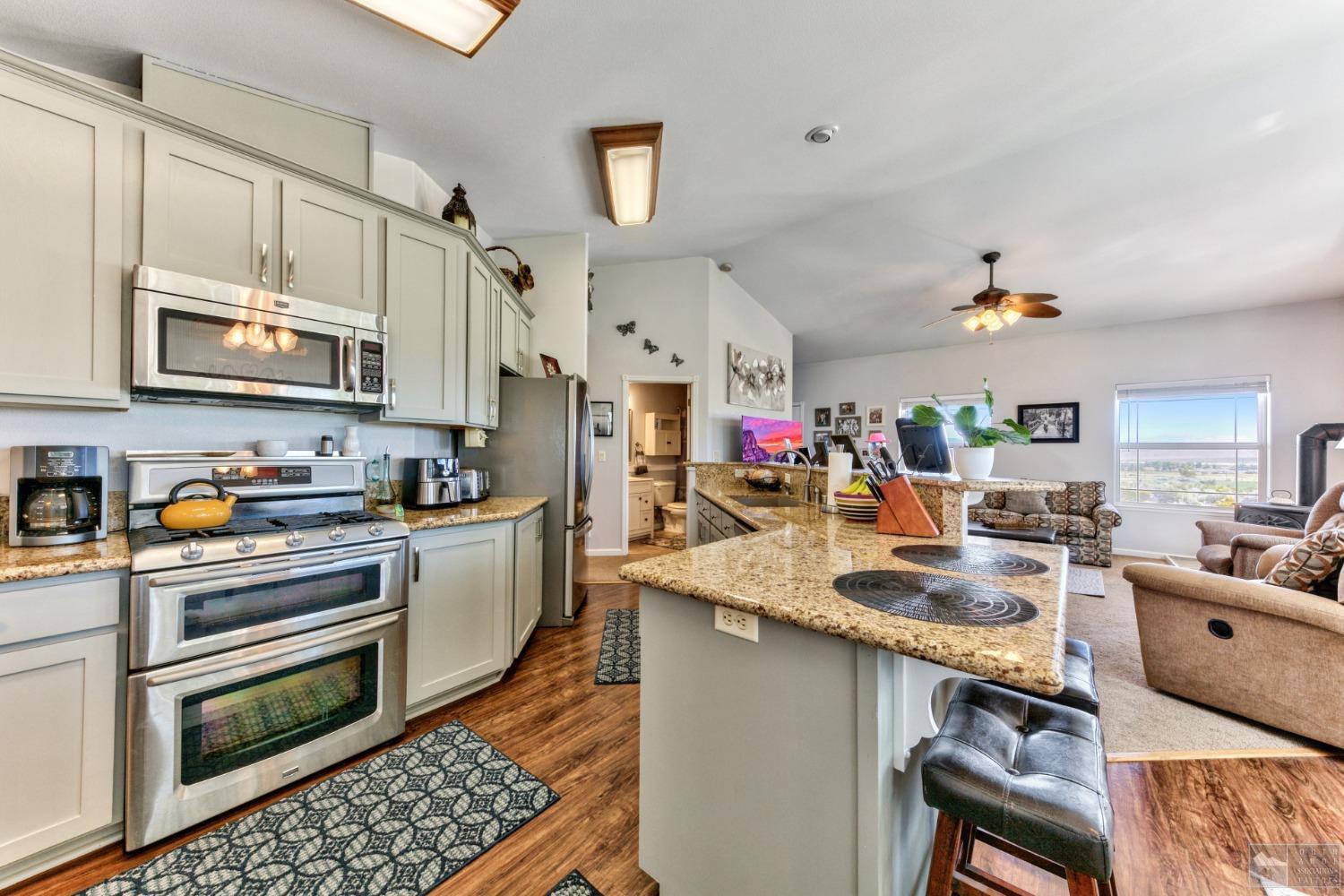 1111 Foothill Road Markleeville, CA 96120 - Photo 22 of 28 a open kitchen with stainless steel appliances granite countertop a stove and cabinets