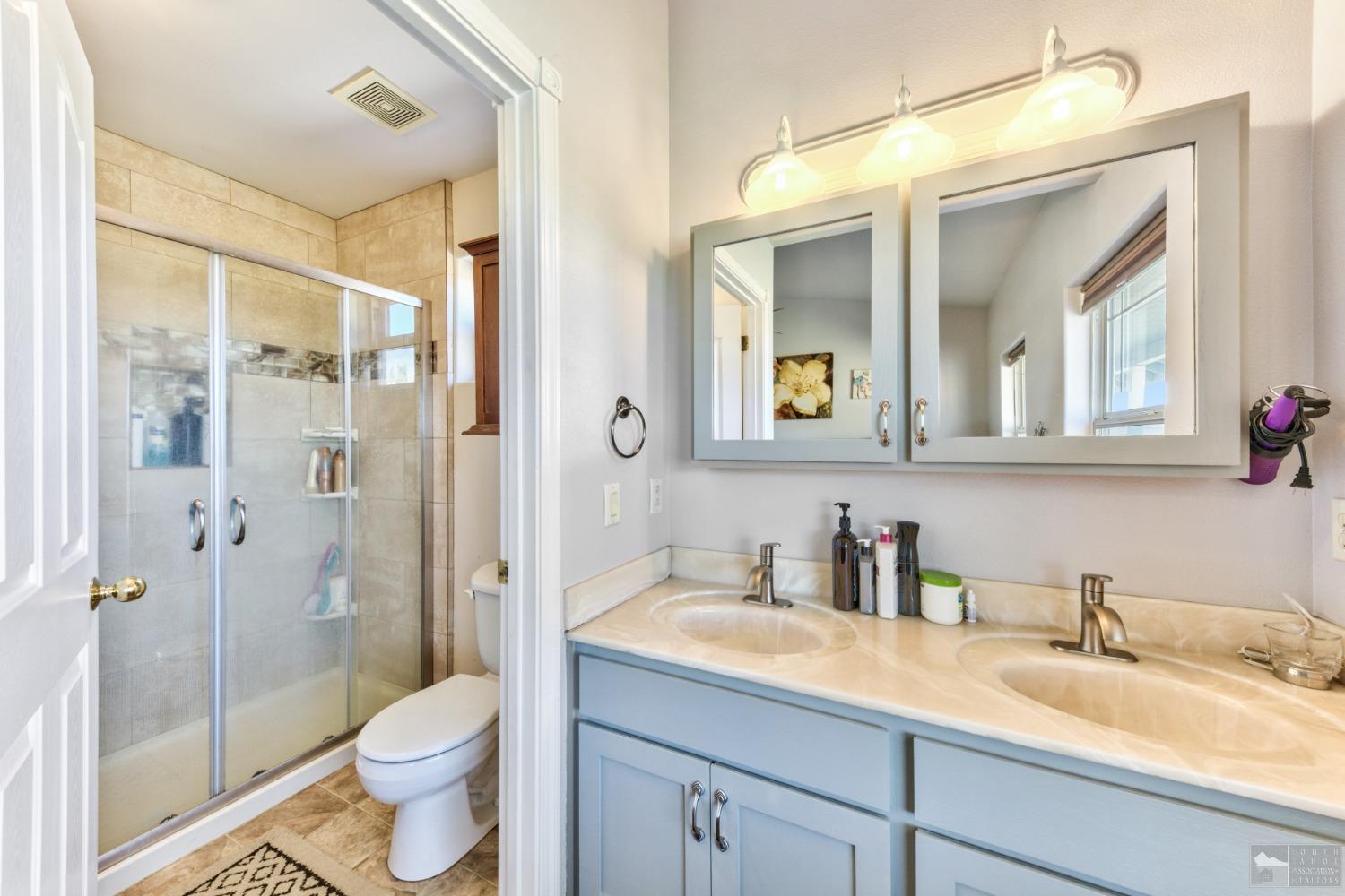 1111 Foothill Road Markleeville, CA 96120 - Photo 26 of 28 a bathroom with a granite countertop sink toilet and shower