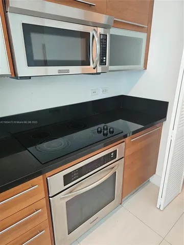 a kitchen with granite countertop cabinets and steel stainless steel appliances