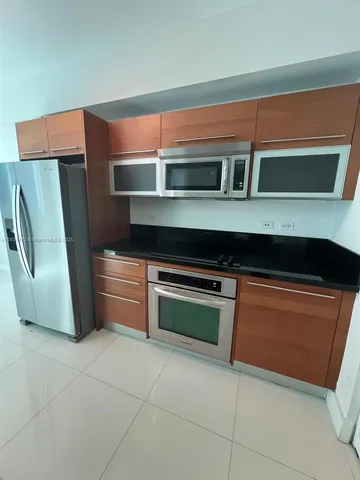 a kitchen with stainless steel appliances a refrigerator and a sink