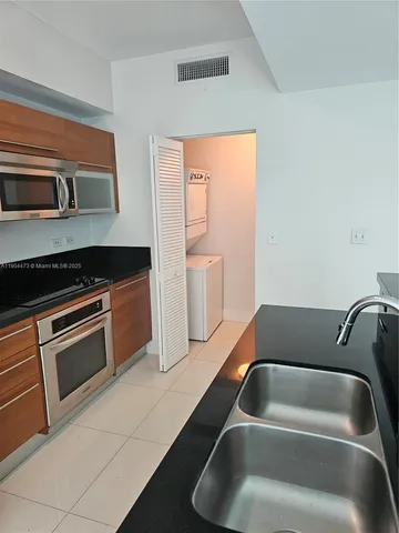 a kitchen that has a sink and a stove