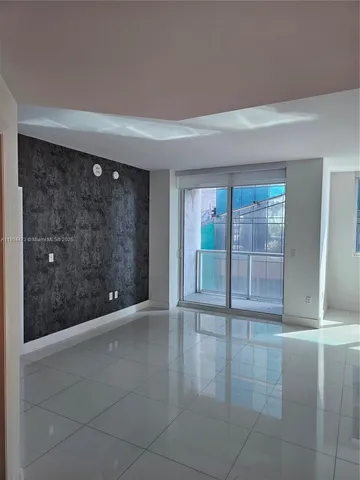 a view of an empty room with glass door