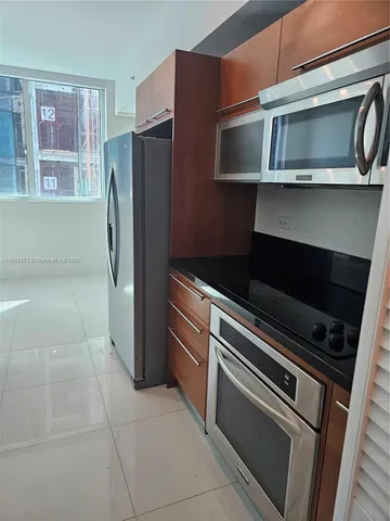 a kitchen with a refrigerator stove and microwave