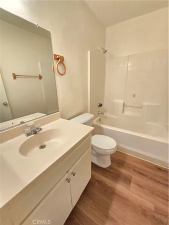 a bathroom with a double vanity sink toilet mirror and bathtub