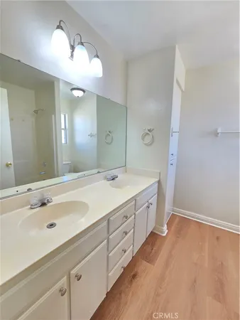 a spacious bathroom with a double vanity sink and a mirror